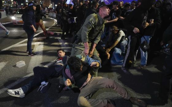 Police drag Israeli protesters through street in Jerusalem. 